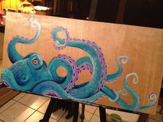 an octopus painting on a wooden easel