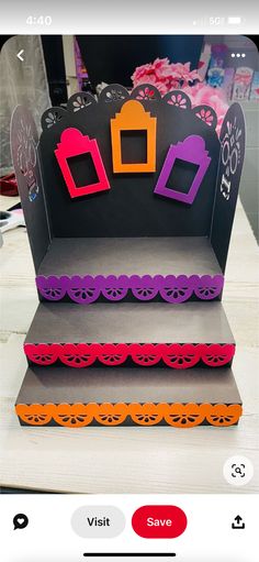 an open box with some paper cutouts on it