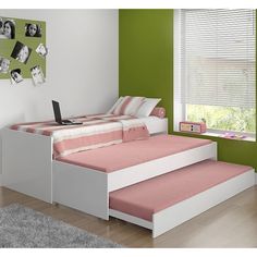 a bedroom with green walls and white furniture in the corner, along with a pink bed