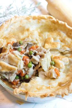 a chicken pot pie with peas and carrots