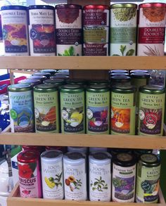 a shelf filled with lots of different types of teas on top of each other