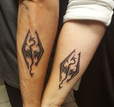 two people with matching tattoos on their arms