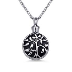 the tree of life pendant is shown in black and white, on a silver chain