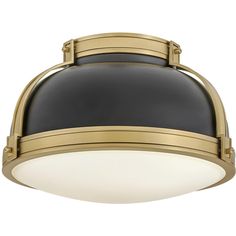 a black and gold ceiling light with an oval shade on the top, against a white background