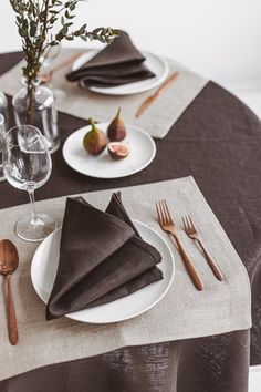 the table is set with place settings and utensils for two people to eat