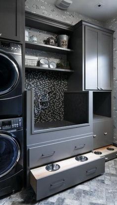 a washer and dryer are in the middle of a room with gray walls