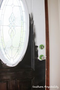 a black door with a stained glass window