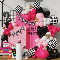 a table topped with balloons and other decorations