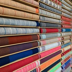 a wall with many different colored fabrics on it