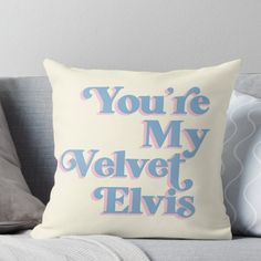 the words you're my velvet elvis on a white and blue pillow sitting on a couch