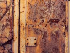 an old rusted metal door is shown