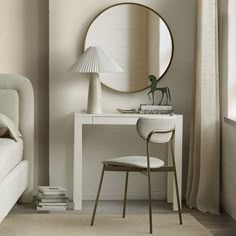 a white desk with a mirror and chair