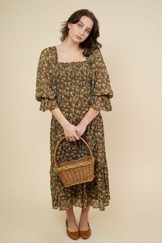 Romantic cottage core inspired midi dress in loose fit style. This dress comes in a cocoa brown that features a smocked bodice detailing with an allover mustard small flower print. Square ruffle neckline , 3/4 balloon sleeves with elastic cuffs. Slips on for wear Mother Friendly 100% Cotton Hand Wash Cold / Line Dry Measurements & Fit Notes Olivia and Rosa are both wearing a size Small Spring Peasant Dress With Smocked Cuffs, Fall Brunch Midi Dress With Ditsy Floral Print, Spring Brown Dress With Gathered Sleeves, Brown Midi Dress With Smocked Bodice For Brunch, Brown Smocked Bodice Midi Dress For Brunch, Brown Spring Dress With Gathered Sleeves, Casual Smocked Dress For Spring Gatherings, Brown Peasant Dress For Fall, Cottagecore Brown Dress For Spring