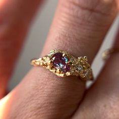 "This Juniper Cluster Ring features a shimmering purple, pear cut alexandrite set asymmetrically amongst a cluster of diamonds. The rustic and textured band is molded from an Ashe Juniper tree. 100% recycled gold  100% lab grown diamond & alexandrite Every single ring in my collection is designed, sculpted and produced entirely by hand. I never use computers and I never use \"off-the-shelf\" designs that you see in so many jewelry stores. Each ring begins by casting an actual twig or piece of ba Asymmetrical Gold Ring, Artsy Engagement Rings Unique, Unique Engagement Rings Art Deco, Bee Engagement Ring, Freeform Engagement Rings, Fairy Style Engagement Ring, Eclectic Rings Engagement, Engagement Rings Organic, Earthy Engagement Ring