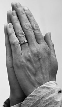 an older woman holding her hands up to her face with the other hand in front of her