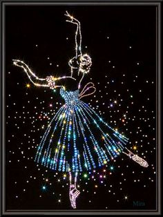 a lit up ballerina dancing in the night sky with stars and sparkles on it