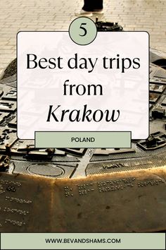 the words best day trips from krakow on top of an old metal object