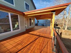 a wooden deck in front of a house