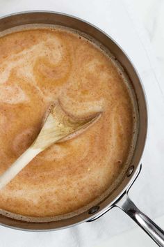 a wooden spoon in a pot filled with liquid