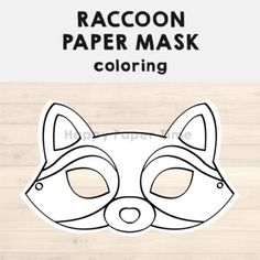 the raccoon paper mask is shown in black and white on a wooden background