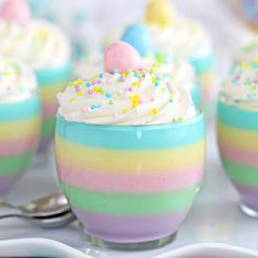 small desserts with white frosting and sprinkles are on the table