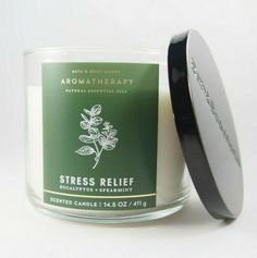 a candle that is sitting in front of a white background with the words aroma therapy on it