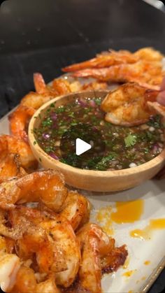 a plate with shrimp and dipping sauce on it