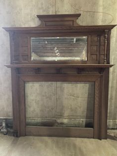 an old fireplace with a mirror on top