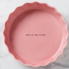 a pink plate with the words piece of cake for pie written on it in cursive writing