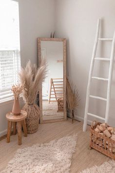 a room with a ladder, mirror and other items on the floor in front of it