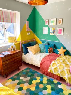 a bedroom with colorful walls and carpeted flooring