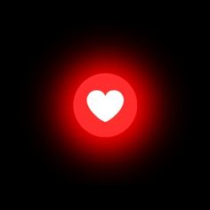 a red light with a white heart in the center on a black background that appears to be dark