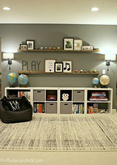 a living room filled with furniture and bookshelves next to a wall mounted tv