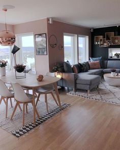 a living room filled with furniture and lots of windows