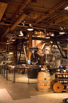 a large room filled with lots of wooden barrels and lights hanging from the ceiling above