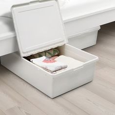 an open suitcase sitting on the floor next to a bed