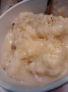 a bowl filled with mashed potatoes on top of a table