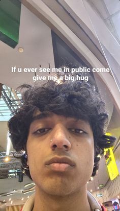 a man with curly hair is looking at the camera and has a quote above his head