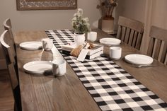 a dining room table is set with plates and cups