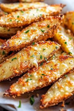 baked potato wedges with parmesan cheese and herbs on the side, ready to be eaten