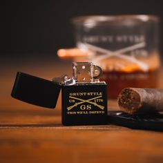 a lighter and some cigars on a table