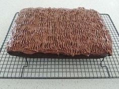 a chocolate cake sitting on top of a cooling rack