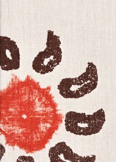 an orange and brown print on a white shirt with black letters in the middle that spell out donuts