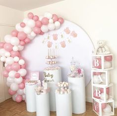 a baby shower party with pink and white balloons