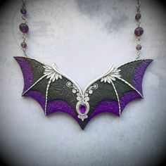 This statement purple and black Gothic bat wings necklace is hand-sculpted of polymer clay and decorated with amethyst gem. Would be perfect for a Halloween witch outfit. Necklace length - 20 inches Bib height - 2 inches Bib width - 4.25 inches Can be made in different colors and sizes - please feel free to contact me if you need a special piece. Black Fantasy Jewelry For Costume, Black Fantasy Costume Jewelry, Fantasy Black Costume Jewelry, Handmade Purple Fantasy Necklaces, Gothic Purple Jewelry For Halloween, Handmade Purple Fantasy Necklace, Gothic Black Amethyst Jewelry, Gothic Purple Necklace For Halloween, Fantasy Style Amethyst Purple Jewelry