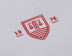 a red and white logo is shown on a piece of paper