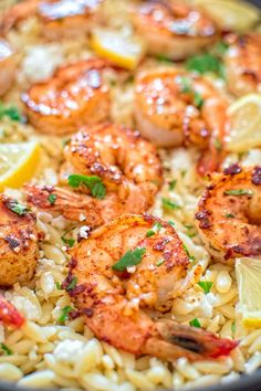 shrimp and rice with lemon wedges in a skillet, ready to be eaten