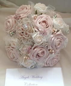 a bridal bouquet with pink roses and pearls