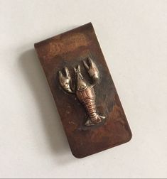 an elephant's paw is attached to a metal object on a white table top