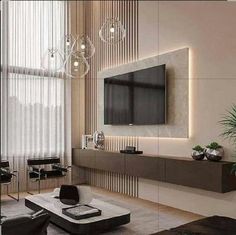 a living room with a large tv mounted to the wall